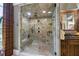 Walk-in shower features stone tile, glass enclosure, and overhead shower head at 4239 Lower Jersey Rd, Covington, GA 30014