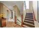 Elegant staircase with carpeted steps and wood railings, connecting the home's levels at 4239 Lower Jersey Rd, Covington, GA 30014