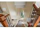 Carpeted staircase with hardwood banister, iron railings, and a view of outdoors at 4239 Lower Jersey Rd, Covington, GA 30014