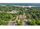 Aerial view showcases the community's townhomes nestled among lush trees near a lake and local shopping at 4571 Academy St, Acworth, GA 30101