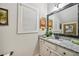 Well-lit bathroom with granite vanity, large framed mirror, and natural light from the window at 4571 Academy St, Acworth, GA 30101
