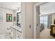 Bathroom featuring double sinks with granite countertops and access to bedroom at 4571 Academy St, Acworth, GA 30101