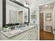 Bathroom featuring double sinks with granite countertops and natural lighting at 4571 Academy St, Acworth, GA 30101