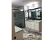 Modern bathroom featuring a glass-enclosed shower, white cabinetry, and granite countertops at 4571 Academy St, Acworth, GA 30101