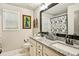 Bathroom featuring double sinks with granite countertops and natural lighting at 4571 Academy St, Acworth, GA 30101