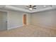 Spacious bedroom with neutral tones, plush carpeting, a ceiling fan, and ample natural light at 4571 Academy St, Acworth, GA 30101