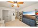 Bedroom featuring a ceiling fan, built-in shelving, and access to another room at 4571 Academy St, Acworth, GA 30101