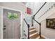 Welcoming entryway with stairs and natural light filtering through the door and windows at 4571 Academy St, Acworth, GA 30101