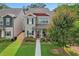 Charming two-story home featuring a welcoming front porch, well-manicured lawn, and lush landscaping at 4571 Academy St, Acworth, GA 30101