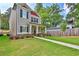 Charming two-story home featuring black shutters, a well-manicured lawn and mature trees at 4571 Academy St, Acworth, GA 30101