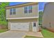 Home exterior featuring a two-car garage with attached driveway in a lovely neighborhood at 4571 Academy St, Acworth, GA 30101