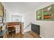 Hallway with hardwood floors, desk, chair, and a barn door to the side in the wall at 4571 Academy St, Acworth, GA 30101