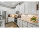 Well-equipped kitchen featuring granite countertops, stainless steel appliances, and white cabinetry at 4571 Academy St, Acworth, GA 30101