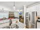 Open-concept kitchen with stainless steel appliances, granite counters, and views into living area at 4571 Academy St, Acworth, GA 30101
