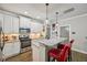 A modern kitchen with stainless steel appliances, granite countertops, and seating at the breakfast bar at 4571 Academy St, Acworth, GA 30101
