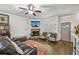 Comfortable living room with a fireplace, TV, and a gray front door with sidelight windows at 4571 Academy St, Acworth, GA 30101