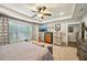Sun-filled main bedroom featuring a ceiling fan, large windows, and neutral colors at 4571 Academy St, Acworth, GA 30101