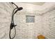 Tiled shower featuring a dark shower head and decorative mosaic inset shelf at 4571 Academy St, Acworth, GA 30101