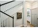 An interior view of the stairway featuring white rails, black handrail, and a decorative picture hanging on the wall at 4571 Academy St, Acworth, GA 30101