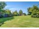 Spacious backyard with manicured lawn, storage shed, and a sturdy wooden fence at 2321 Sunnyview Ln, Dacula, GA 30019