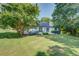 Private backyard featuring a patio area, a well-maintained lawn, and mature trees at 2321 Sunnyview Ln, Dacula, GA 30019