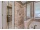 Bathroom with a glass shower, soaking tub, and tile surround at 2321 Sunnyview Ln, Dacula, GA 30019