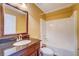 Bright bathroom featuring a single sink vanity with a dark countertop and a shower-tub combination at 2321 Sunnyview Ln, Dacula, GA 30019