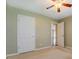 Neutral bedroom with a ceiling fan and closet doors, offering ample storage space at 2321 Sunnyview Ln, Dacula, GA 30019