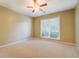 Spacious bedroom featuring a ceiling fan and a large window providing natural light at 2321 Sunnyview Ln, Dacula, GA 30019