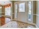 Inviting entryway with a white front door with decorative glass and beige tile flooring with black accents at 2321 Sunnyview Ln, Dacula, GA 30019