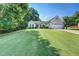 Well-maintained home with a manicured lawn, lush greenery, and a charming red front door at 2321 Sunnyview Ln, Dacula, GA 30019