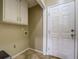Functional laundry room features tile floor and white cabinets at 2321 Sunnyview Ln, Dacula, GA 30019