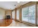 Bright living room with a fireplace and a view of the backyard through large windows at 2321 Sunnyview Ln, Dacula, GA 30019