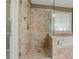 Elegant tiled shower with glass door and natural light from the window at 2321 Sunnyview Ln, Dacula, GA 30019