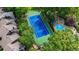 Aerial view showing the tennis court and swimming pool nestled amongst the townhome complex at 12 Ivy Ne Rdg, Atlanta, GA 30342