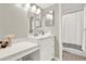 Bright bathroom with a vanity, sink, mirror, and a shower with a white shower curtain at 12 Ivy Ne Rdg, Atlanta, GA 30342