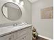 Modern bathroom vanity with marble countertop and a round mirror at 12 Ivy Ne Rdg, Atlanta, GA 30342