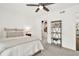 Bright bedroom with a ceiling fan, closet, and open shelving with a view to the hall at 12 Ivy Ne Rdg, Atlanta, GA 30342