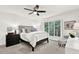 A comfortable bedroom with a ceiling fan, a window, and neutral-colored carpet at 12 Ivy Ne Rdg, Atlanta, GA 30342