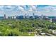 Panoramic skyline view from a neighborhood surrounded by mature trees and townhomes at 12 Ivy Ne Rdg, Atlanta, GA 30342