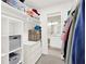 Spacious walk-in closet with custom shelving, drawers, and storage solutions and a view to the bathroom at 12 Ivy Ne Rdg, Atlanta, GA 30342