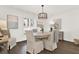 Bright dining room with hardwood floors, elegant lighting, and shuttered window at 12 Ivy Ne Rdg, Atlanta, GA 30342