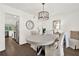 Dining room view into kitchen, hardwood floors, and elegant table setting at 12 Ivy Ne Rdg, Atlanta, GA 30342