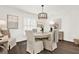 Bright dining room with hardwood floors, elegant lighting, and shuttered window at 12 Ivy Ne Rdg, Atlanta, GA 30342