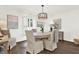 Bright dining room with hardwood floors, elegant lighting, and shuttered window at 12 Ivy Ne Rdg, Atlanta, GA 30342