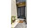 Stylish front door with sidelights, accented by potted plants and a welcome mat at 12 Ivy Ne Rdg, Atlanta, GA 30342