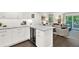 Bright kitchen open to living room with a built-in wine fridge and views of the deck at 12 Ivy Ne Rdg, Atlanta, GA 30342