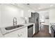 Modern kitchen featuring marble counters, stainless steel sink and appliances at 12 Ivy Ne Rdg, Atlanta, GA 30342