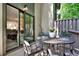 Relax on this covered patio, featuring a wrought iron table and seating for four at 12 Ivy Ne Rdg, Atlanta, GA 30342