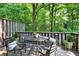Enjoy the serene, wooded view from this charming outdoor dining space on the patio at 12 Ivy Ne Rdg, Atlanta, GA 30342